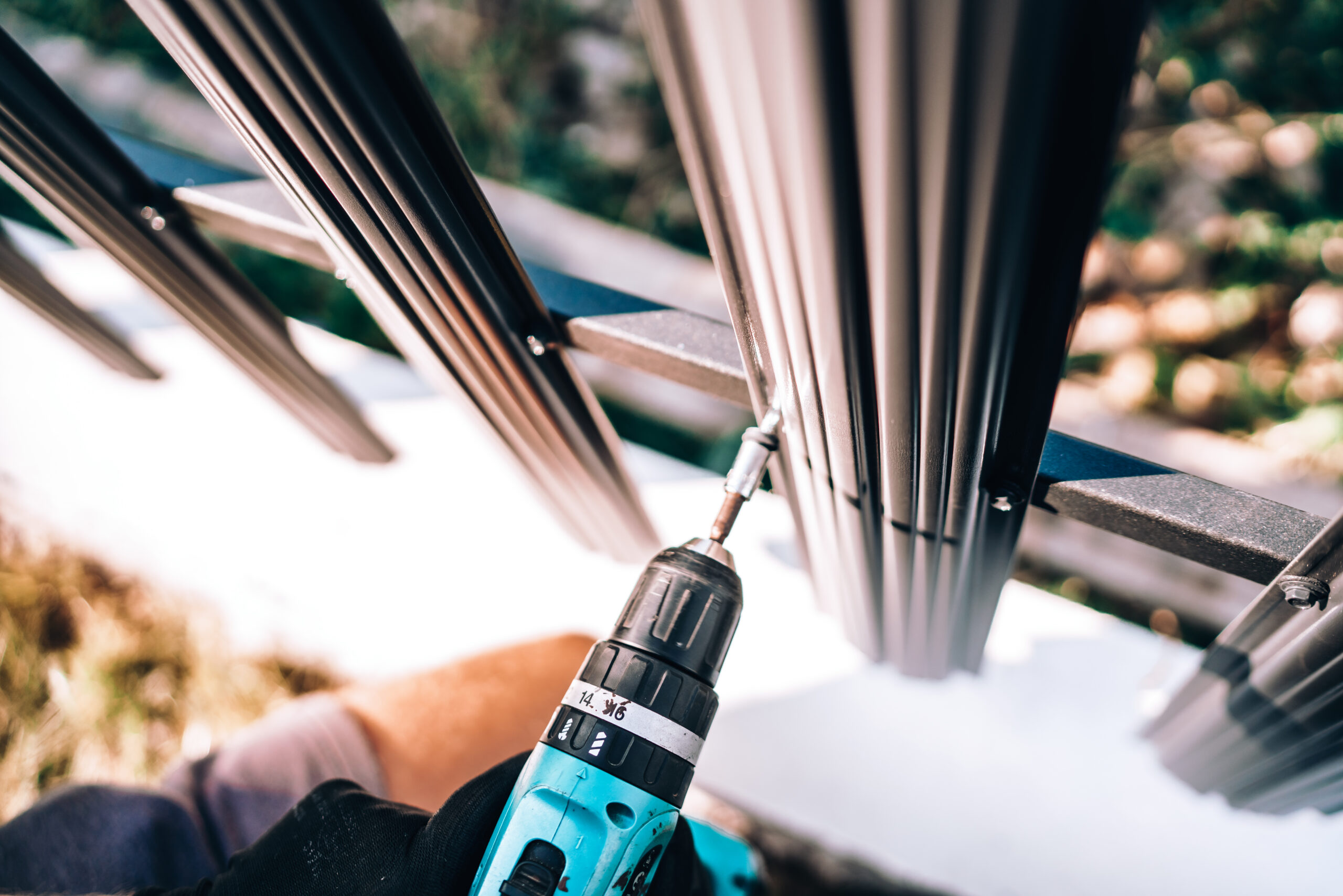 Close up details of construction worker using electrical screwdriver for fastening screws